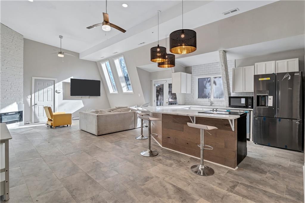 1920 Moores Mill Road Northwest Atlanta, GA 30318 - Photo 6 of 33 a living room with furniture a flat screen tv and appliances