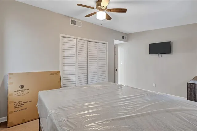 a bedroom with a bed and a tv