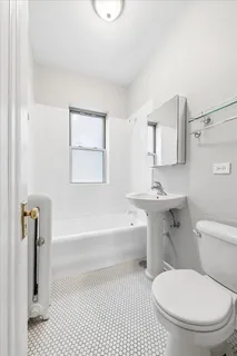 a bathroom with a toilet a sink and bathtub