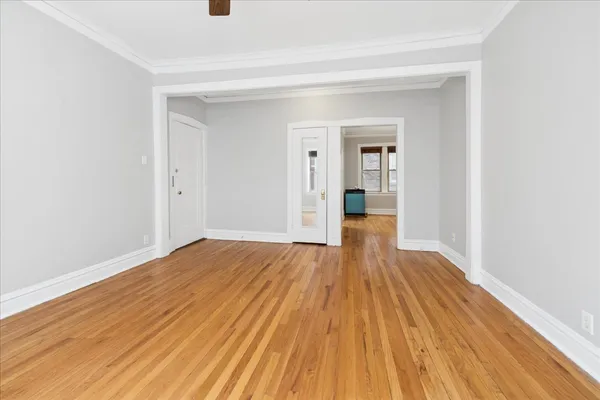 a view of a livingroom with wooden floor and staircase