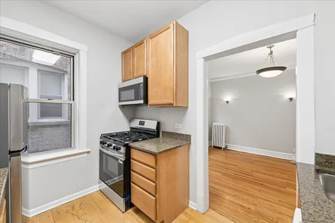 a kitchen with stainless steel appliances granite countertop a stove and a sink