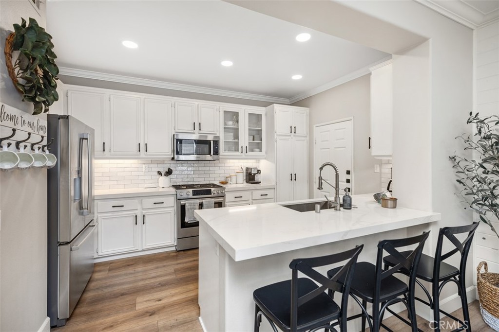 42 Livingston Place Ladera Ranch, CA 92694 - Photo 13 of 34 a kitchen with appliances cabinets and a sink