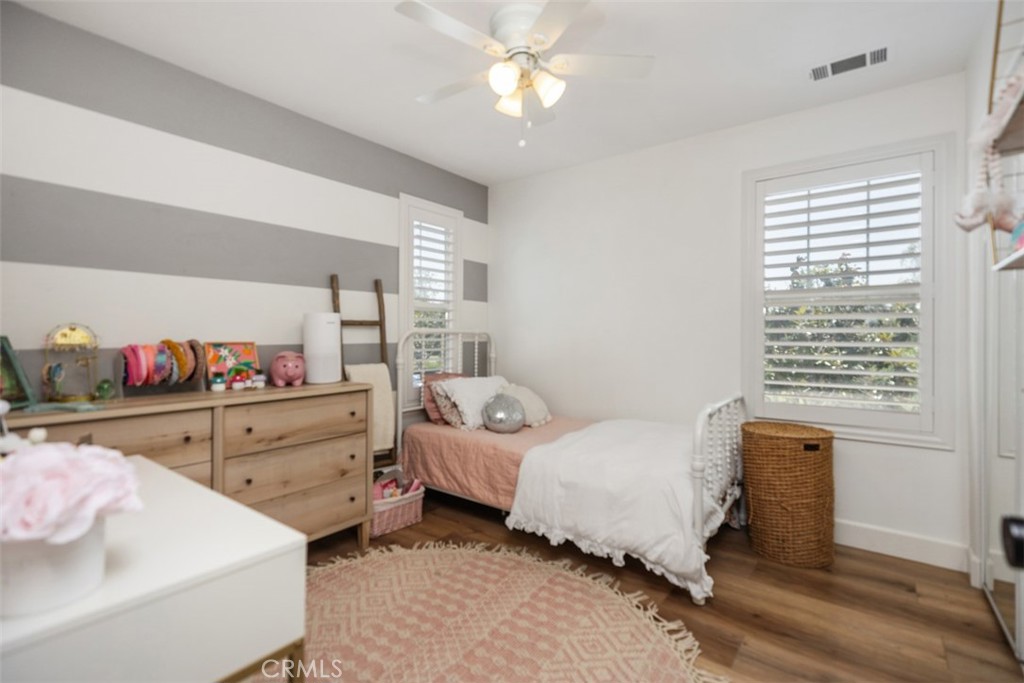 42 Livingston Place Ladera Ranch, CA 92694 - Photo 25 of 34 a bedroom with a bed and a chandelier