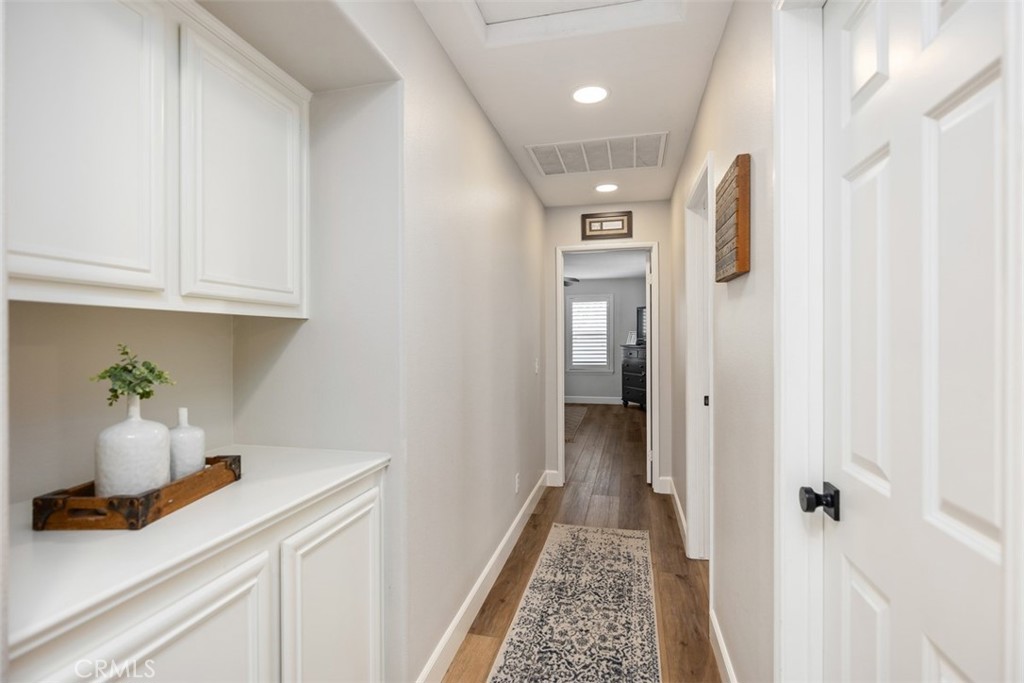 42 Livingston Place Ladera Ranch, CA 92694 - Photo 27 of 34 a hallway with cabinet and mirror