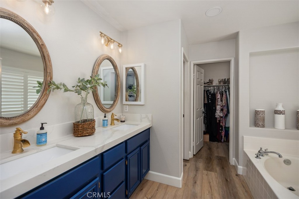 42 Livingston Place Ladera Ranch, CA 92694 - Photo 30 of 34 a bathroom with a double vanity sink and a mirror