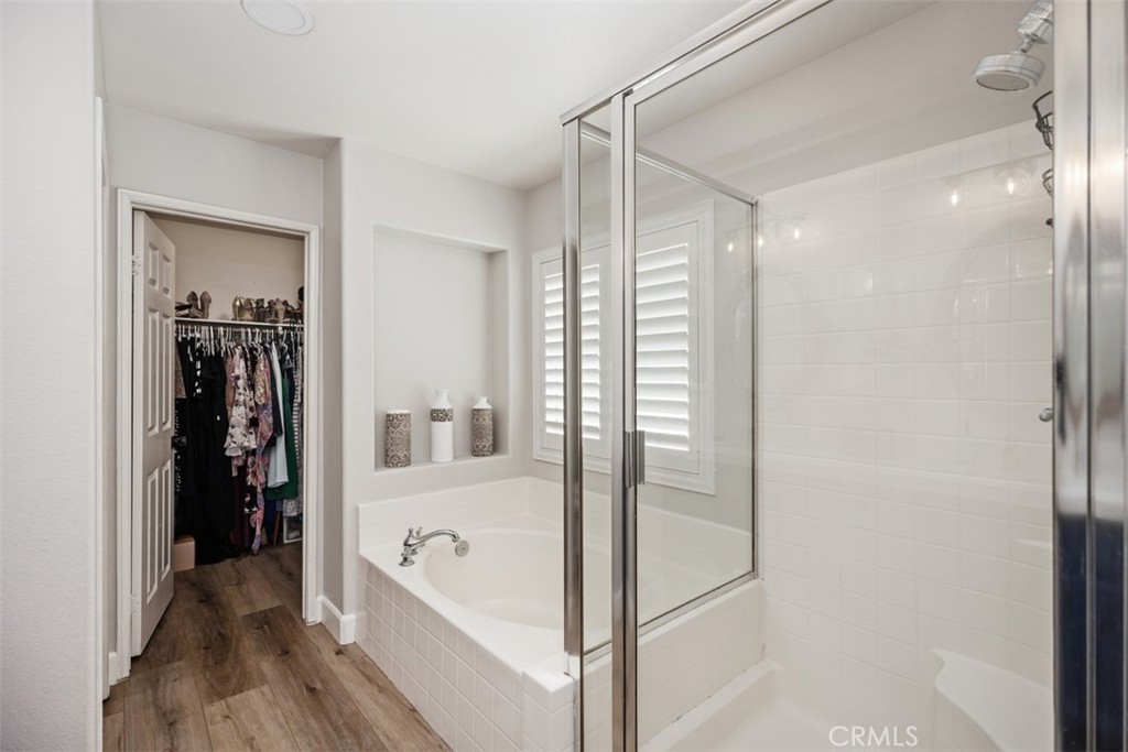 42 Livingston Place Ladera Ranch, CA 92694 - Photo 31 of 34 a bathroom with a bathtub and a shower
