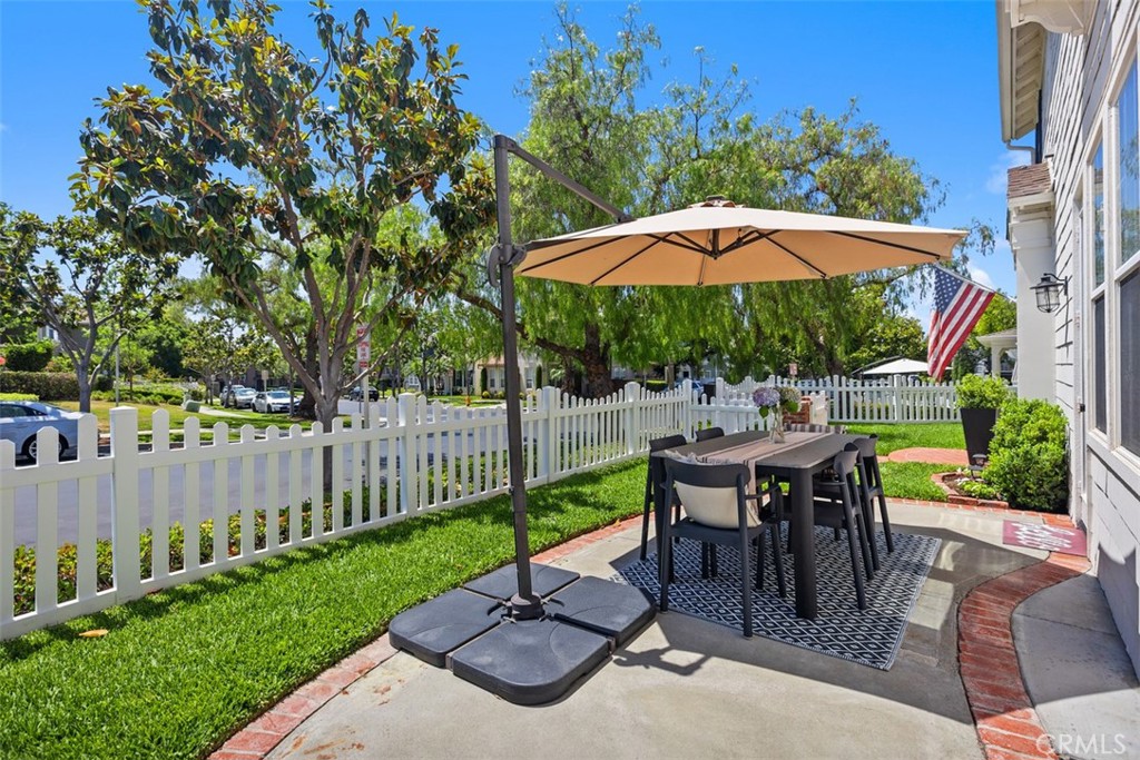 42 Livingston Place Ladera Ranch, CA 92694 - Photo 33 of 34 a view of a patio with a table and chairs under an umbrella