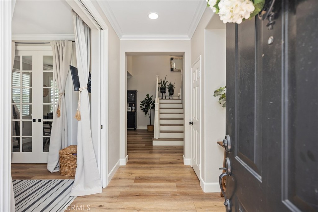 42 Livingston Place Ladera Ranch, CA 92694 - Photo 6 of 34 a view of a hallway with wooden floor and staircase