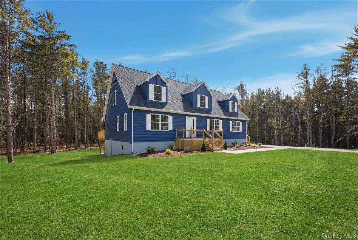 a view of a house with a big yard with plants and trees