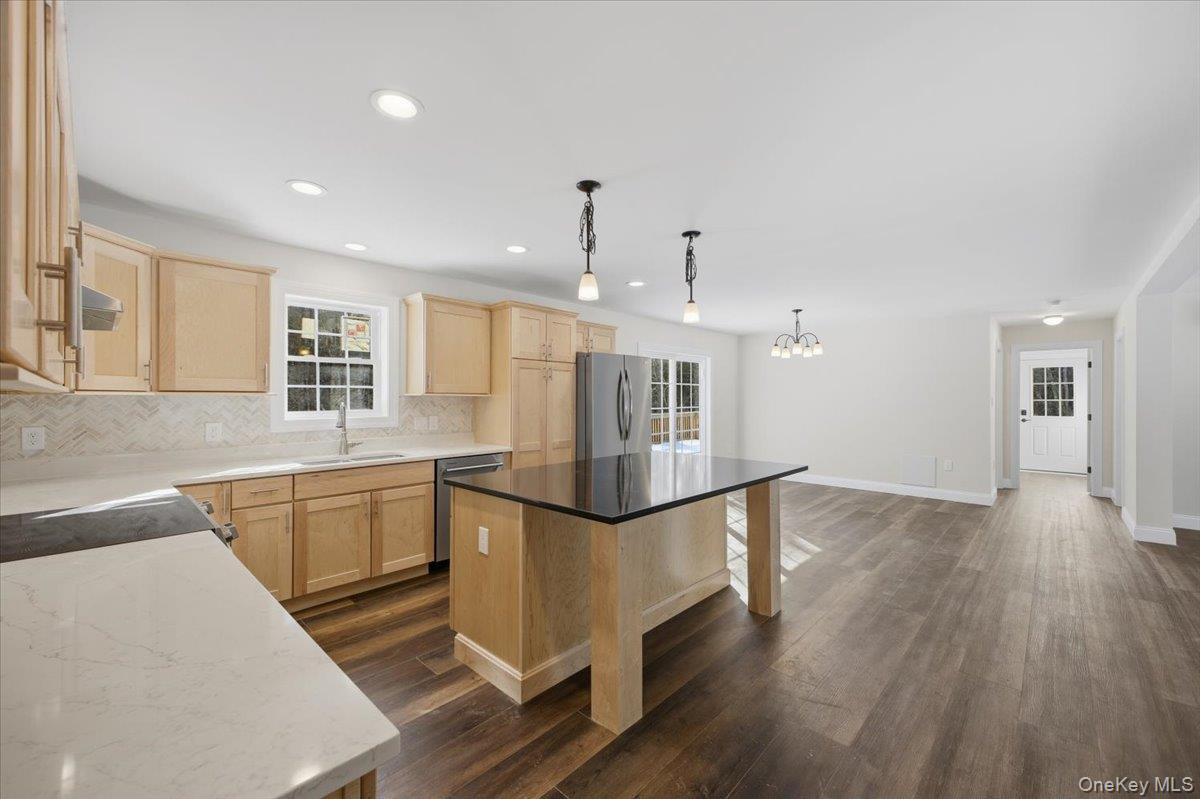 196 Fawn Hill Road Prattsville, NY 12468 - Photo 18 of 45 a kitchen with granite countertop a stove and white cabinets with wooden floor