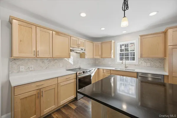 a large kitchen with stainless steel appliances granite countertop a granite counter tops and a window