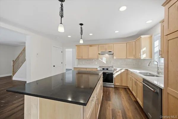 a view of a room with wooden floor and a ceiling fan