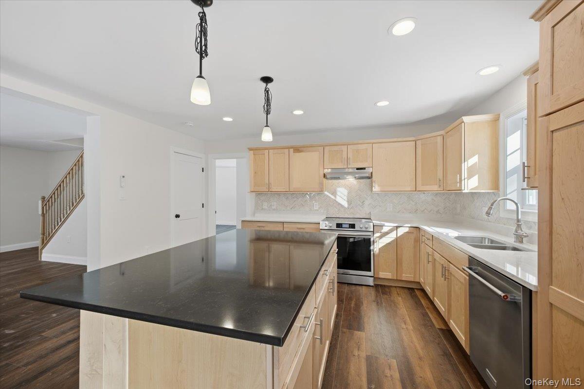 196 Fawn Hill Road Prattsville, NY 12468 - Photo 21 of 45 a kitchen with stainless steel appliances granite countertop a sink a stove and a refrigerator