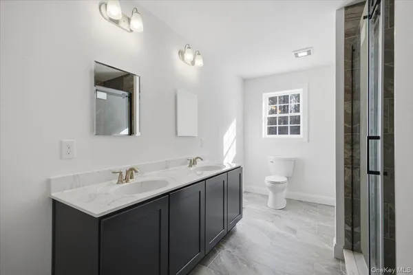 a bathroom with a toilet and a shower