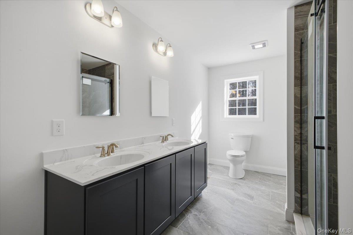196 Fawn Hill Road Prattsville, NY 12468 - Photo 27 of 45 a bathroom with a toilet sink and mirror