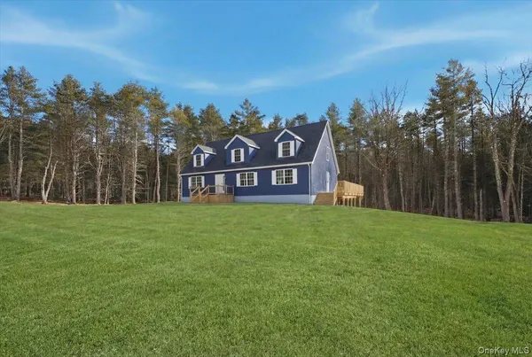 a view of a park with a big yard and large trees
