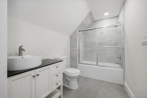 a front view of a house with a yard covered with snow in the background