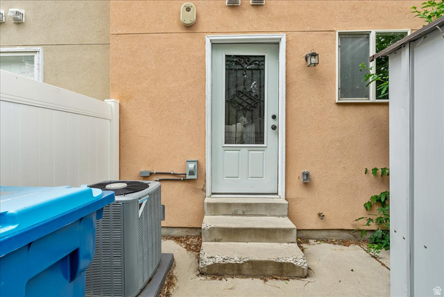 38 South 1000th Street East Payson, UT 84651 - Photo 19 of 19 Exterior entry door with decorative glass inserts, textured stucco finish, and an outdoor wall sconce