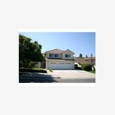 a picture of a bench in front of a house