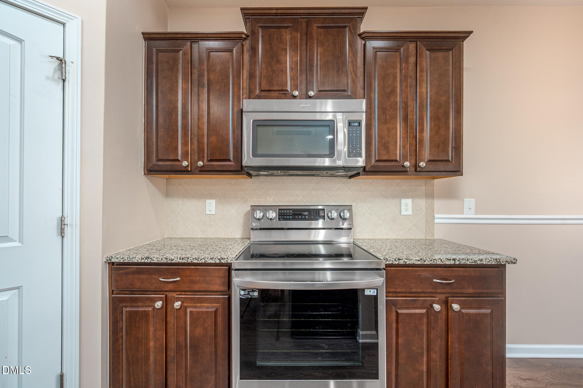 3548 Althorp Drive Raleigh, NC 27616 - Photo 14 of 56 a kitchen with granite countertop a stove microwave and oven