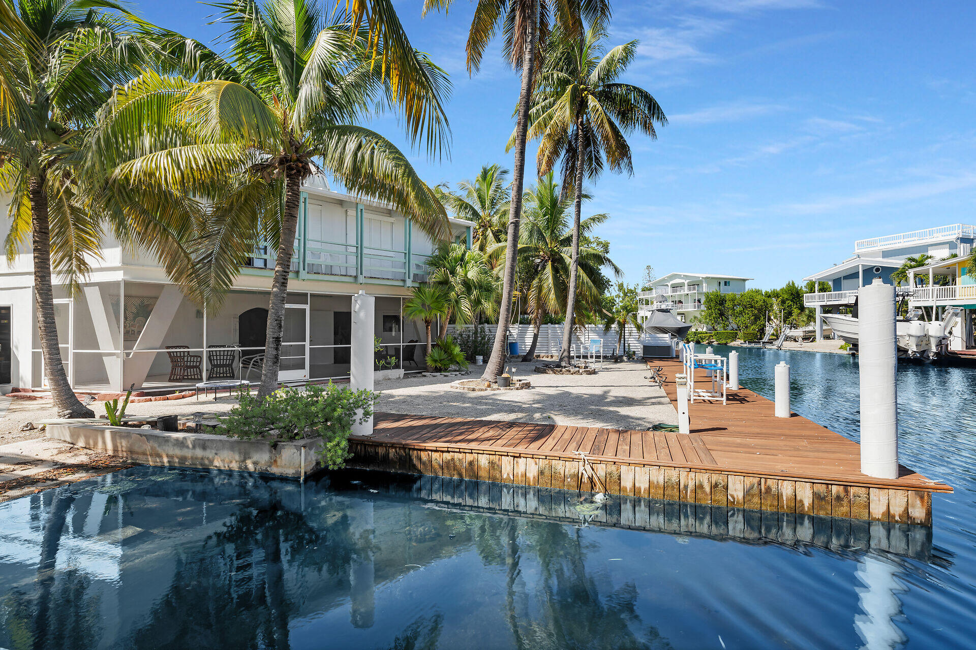 Undisclosed Address Key Largo, FL 33037 - Photo 17 of 69 a view of swimming pool with a table and chairs