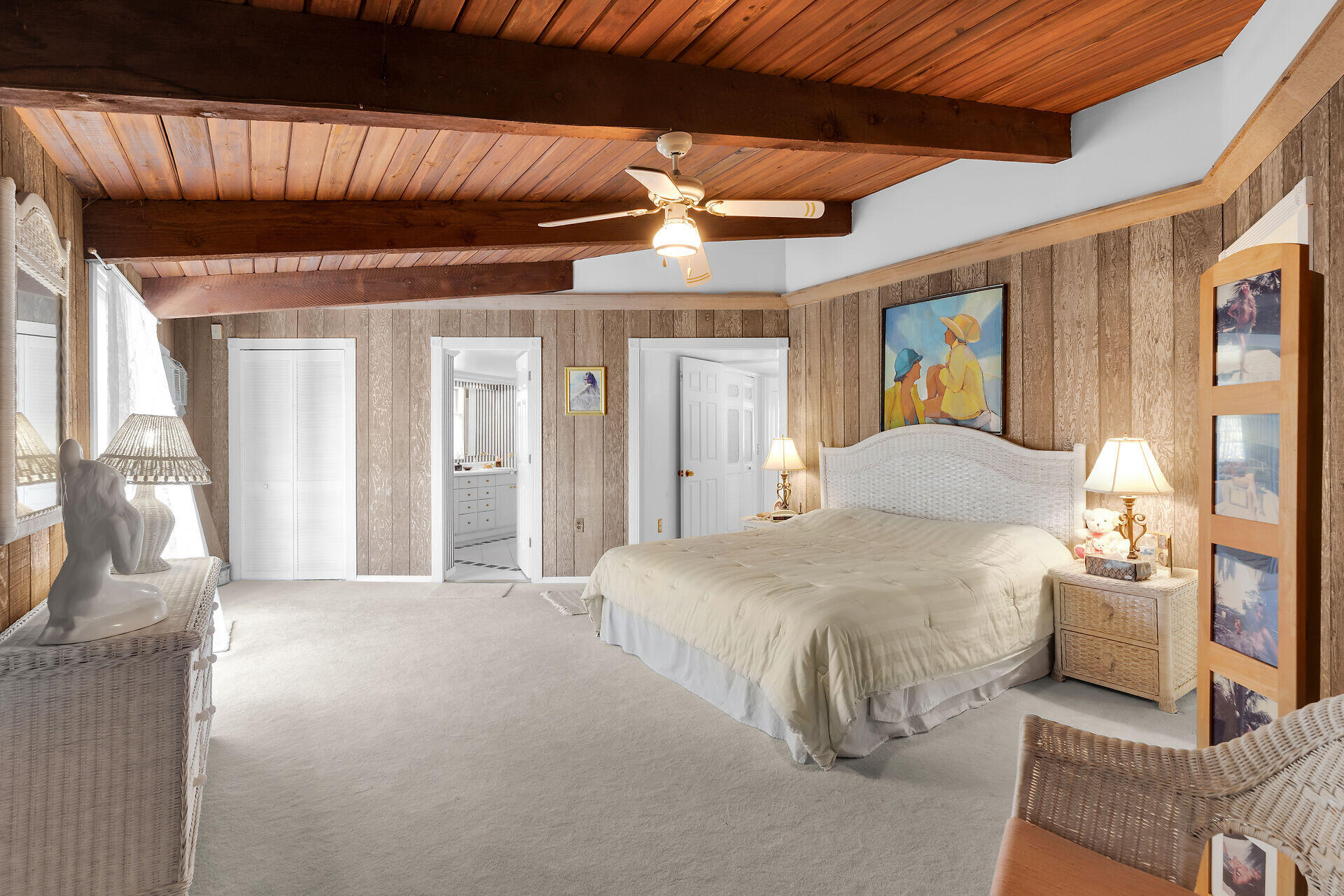 Undisclosed Address Key Largo, FL 33037 - Photo 48 of 69 a spacious bedroom with a bed and a chandelier