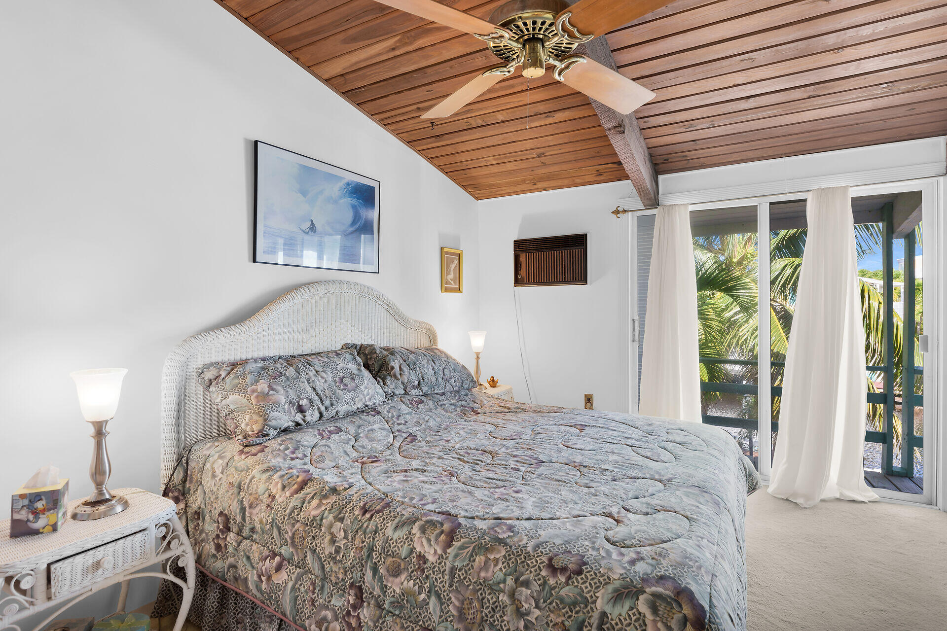 Undisclosed Address Key Largo, FL 33037 - Photo 49 of 69 a bedroom with a large bed and a window