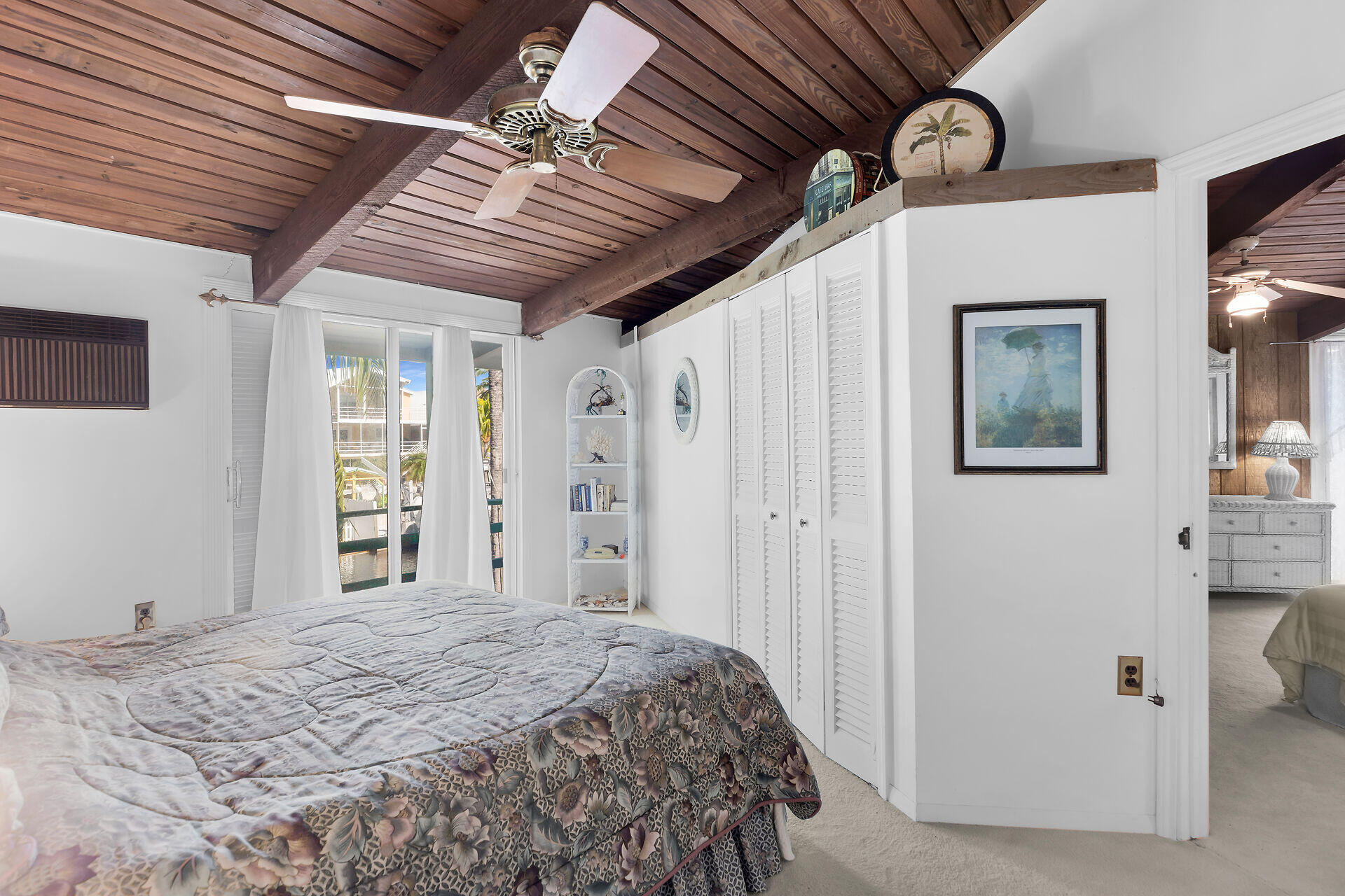 Undisclosed Address Key Largo, FL 33037 - Photo 50 of 69 a bedroom with a bed and a window