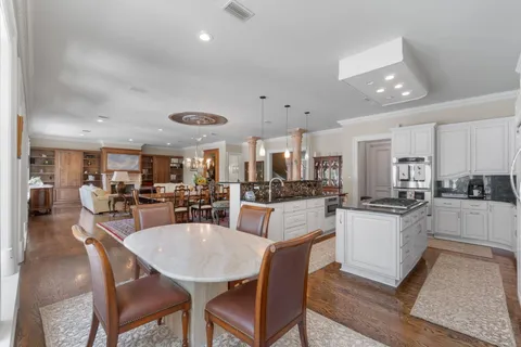 a spacious bedroom with a bed and a chandelier
