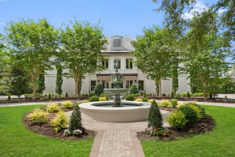 a front view of a house with a garden