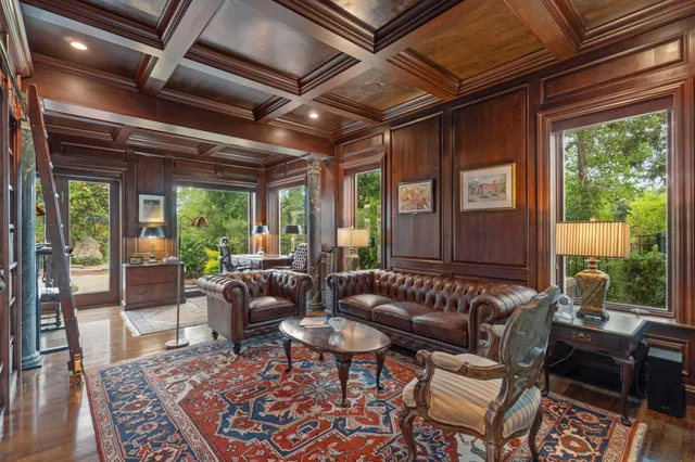 a spacious bedroom with a bed and a chandelier
