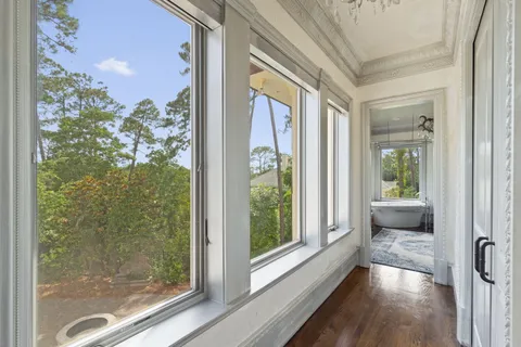 a room with pool table and windows