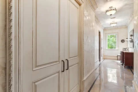a dining room with furniture a floor to ceiling window and a rug