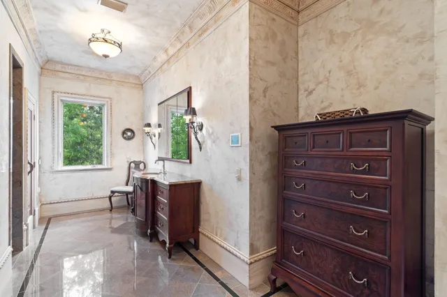 a kitchen with stainless steel appliances kitchen island granite countertop a table chairs sink and cabinets