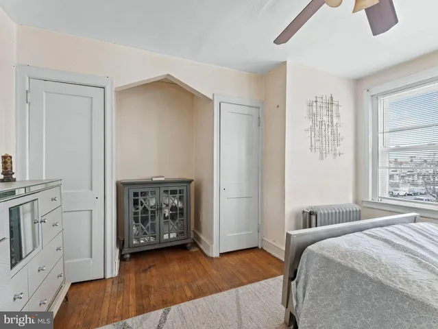 a spacious bedroom with a bed and a fireplace