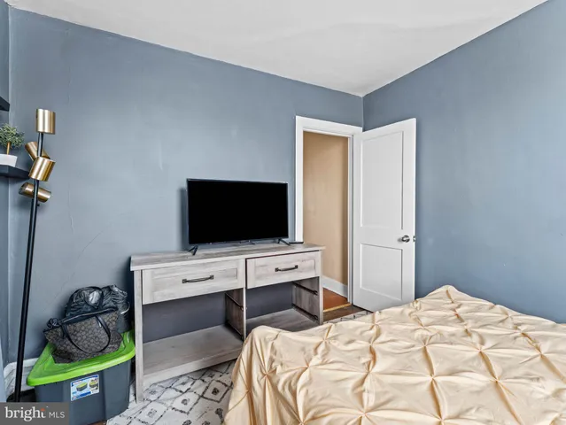 a bedroom with a bed and a flat screen tv