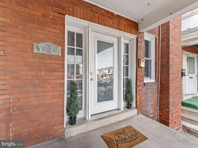 a view of front door of house with a potted plant
