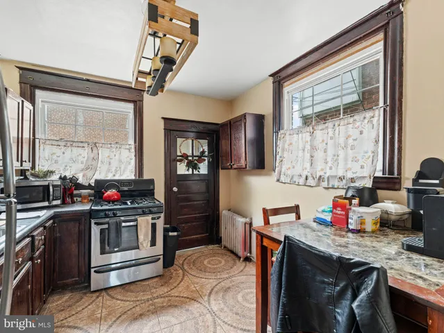 a kitchen with stainless steel appliances granite countertop a stove and a refrigerator