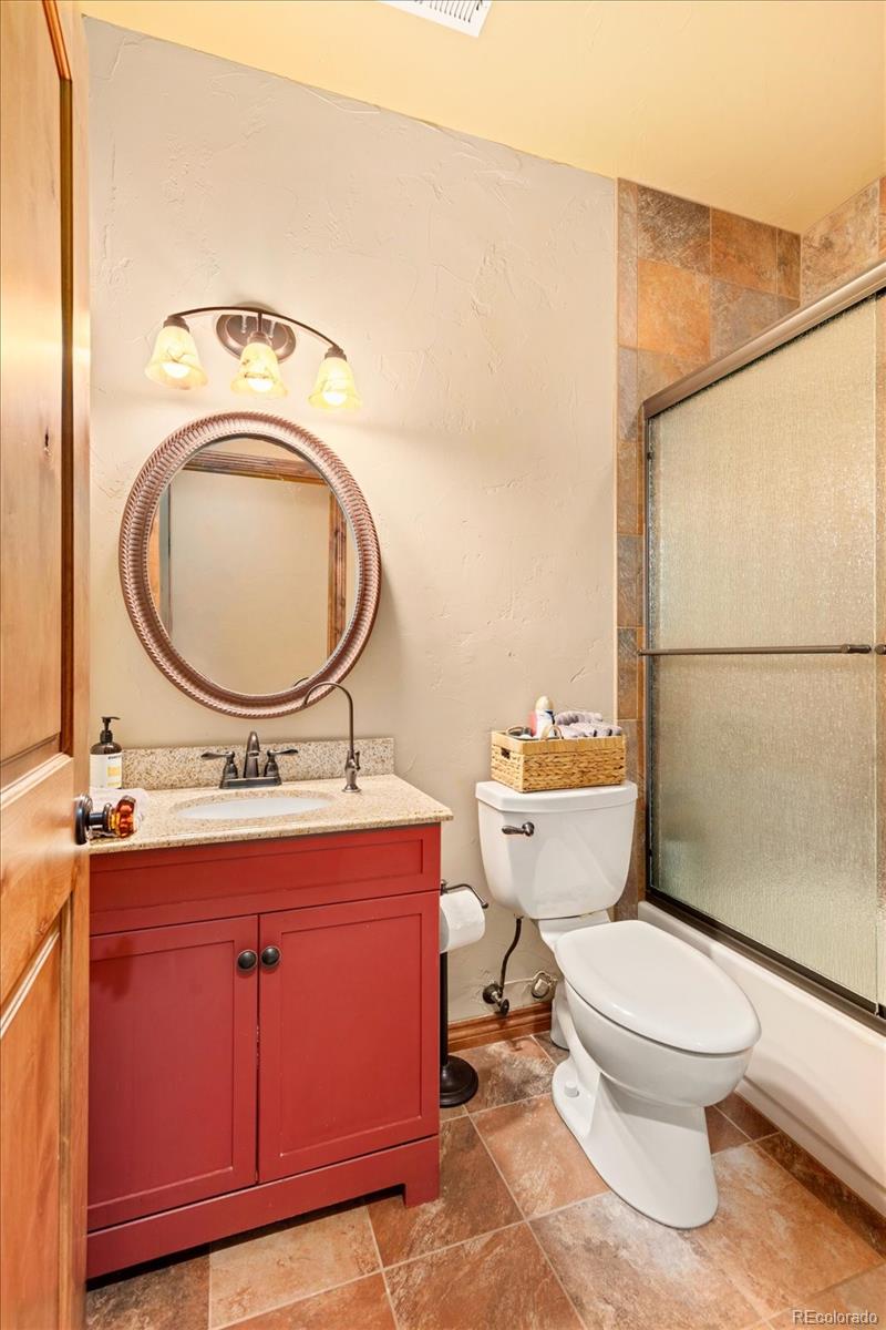 990 Hamilton Creek Road Coaldale, CO 81222 - Photo 25 of 49 a bathroom with a toilet a sink and a mirror