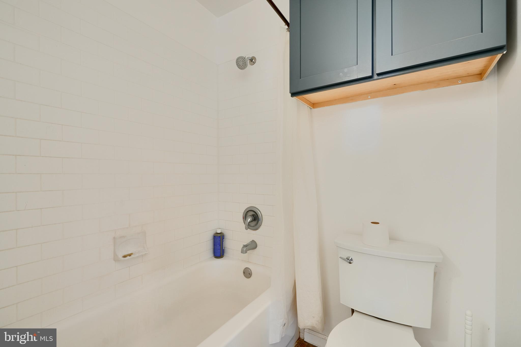 1729 Guilford Avenue, Unit 2 Baltimore, MD 21202 - Photo 12 of 15 a bathroom with a toilet a sink and bathtub