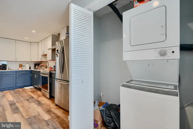 a kitchen with a refrigerator and a stove top oven