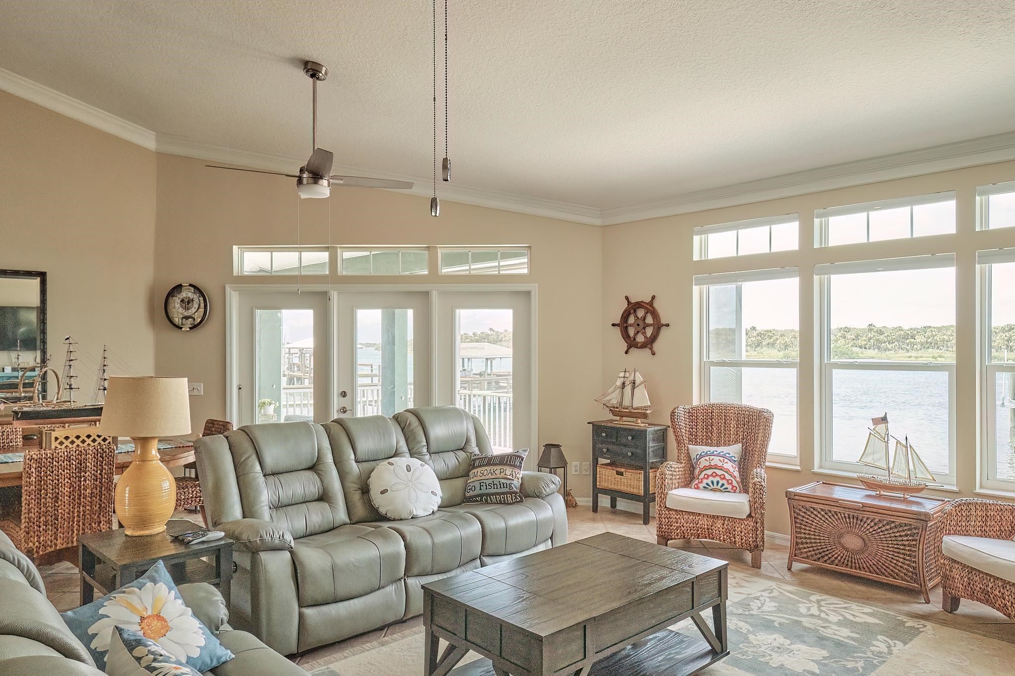 9257 July Lane St. Augustine, FL 32080 - Photo 13 of 48 a living room with furniture and large windows