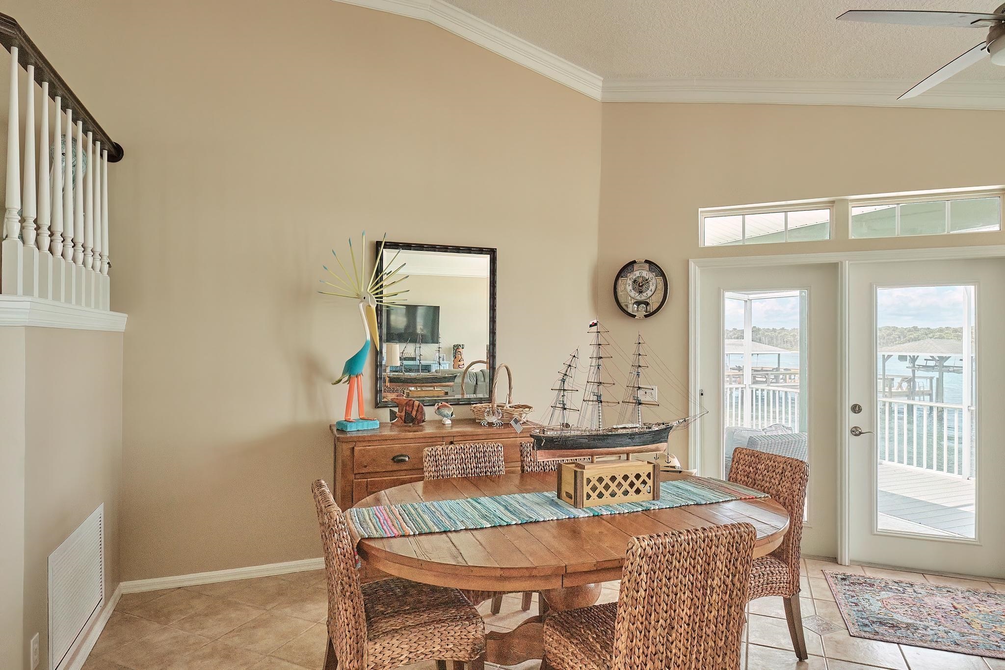 9257 July Lane St. Augustine, FL 32080 - Photo 17 of 48 a view of a a dining room with furniture window and wooden floor