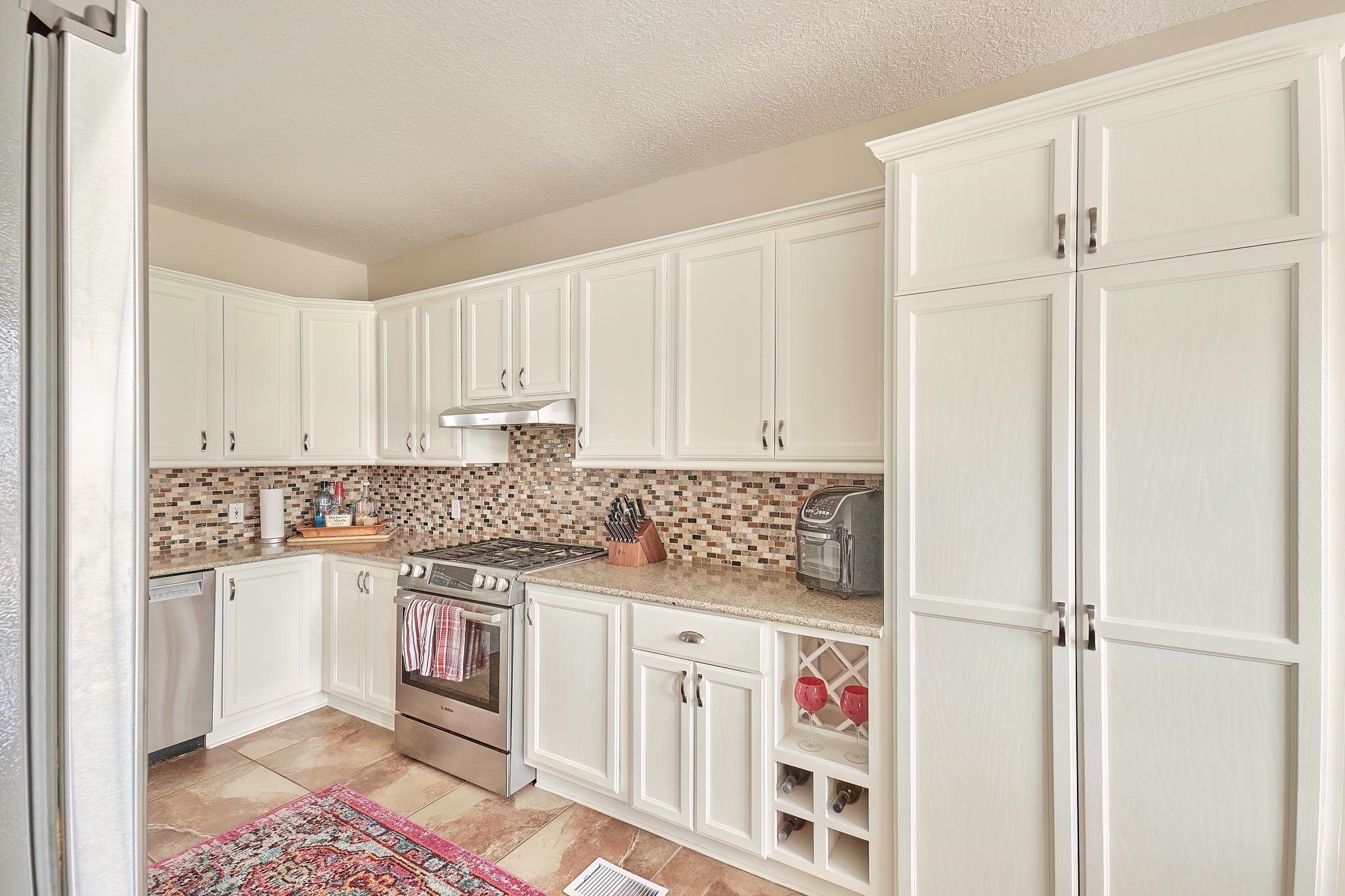 9257 July Lane St. Augustine, FL 32080 - Photo 21 of 48 a utility room with cabinets washer and dryer