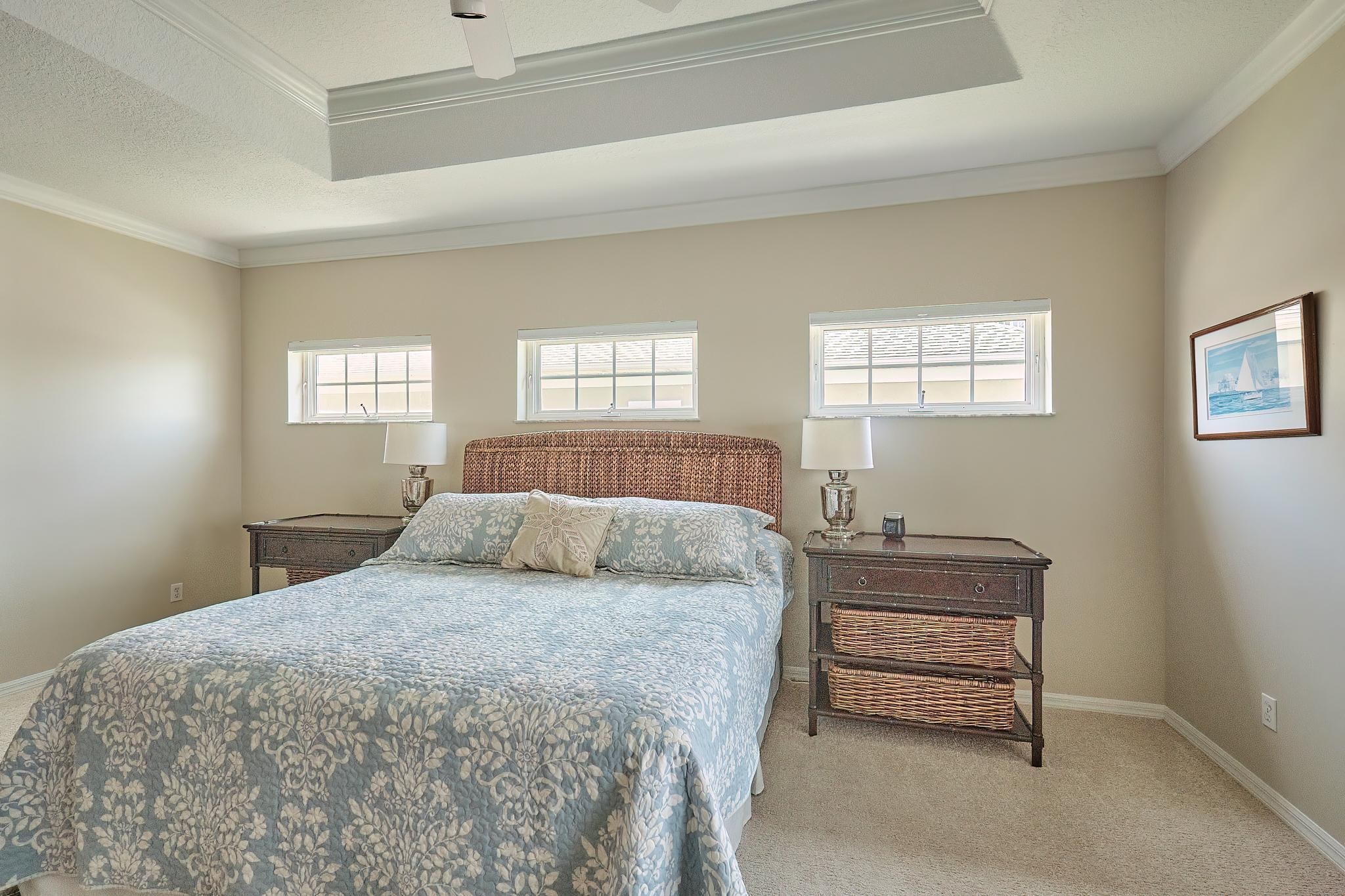 9257 July Lane St. Augustine, FL 32080 - Photo 27 of 48 a bedroom with a bed table and window