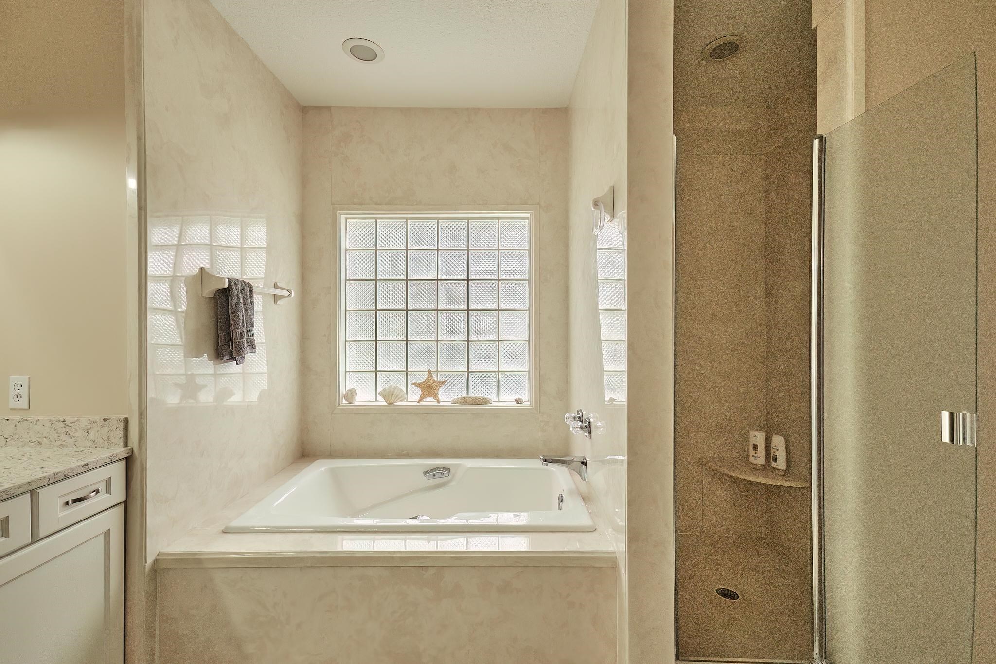 9257 July Lane St. Augustine, FL 32080 - Photo 32 of 48 a bathroom with a bathtub and a shower