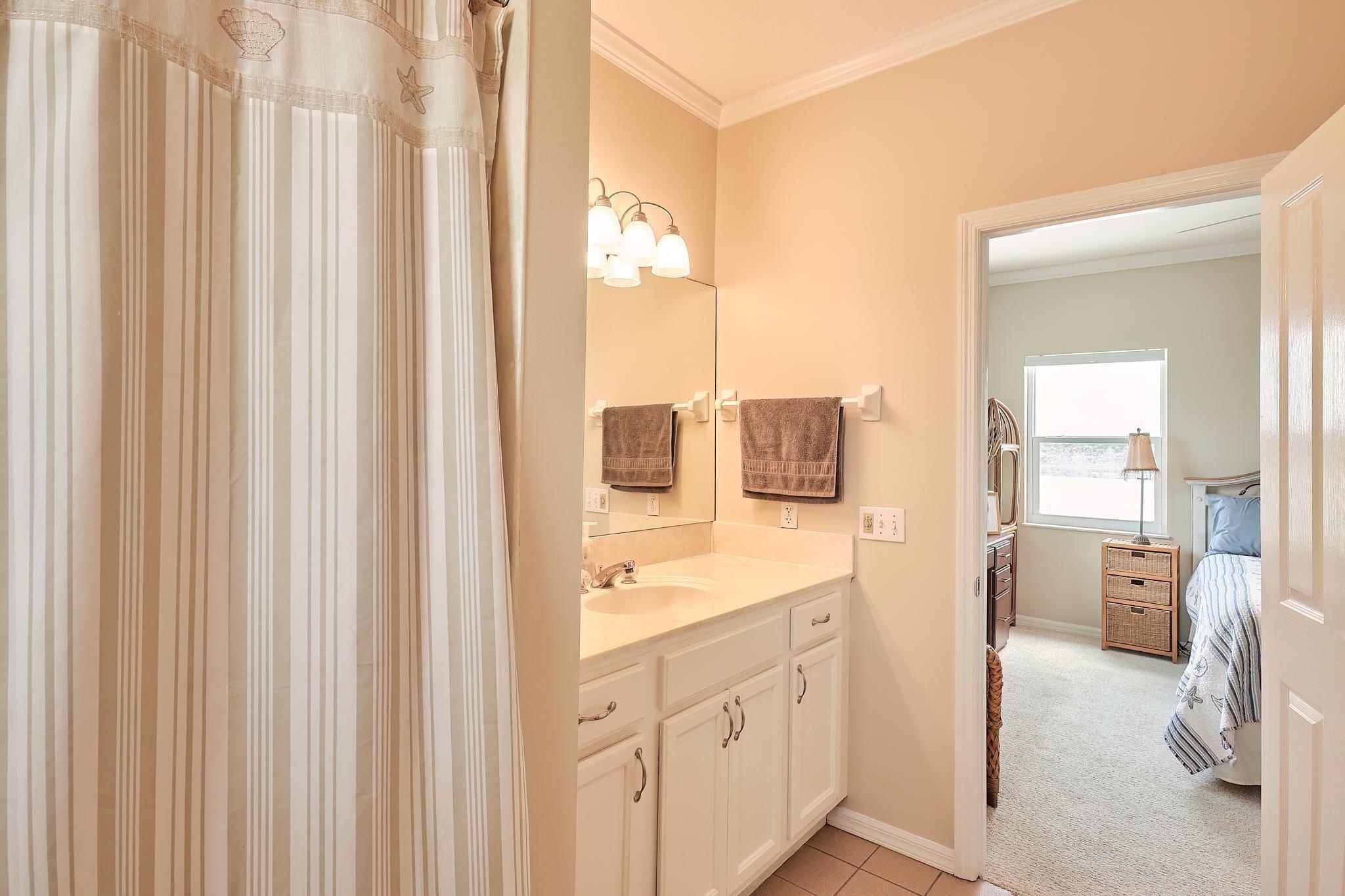 9257 July Lane St. Augustine, FL 32080 - Photo 38 of 48 a spacious bathroom with a double vanity sink a mirror and a shower