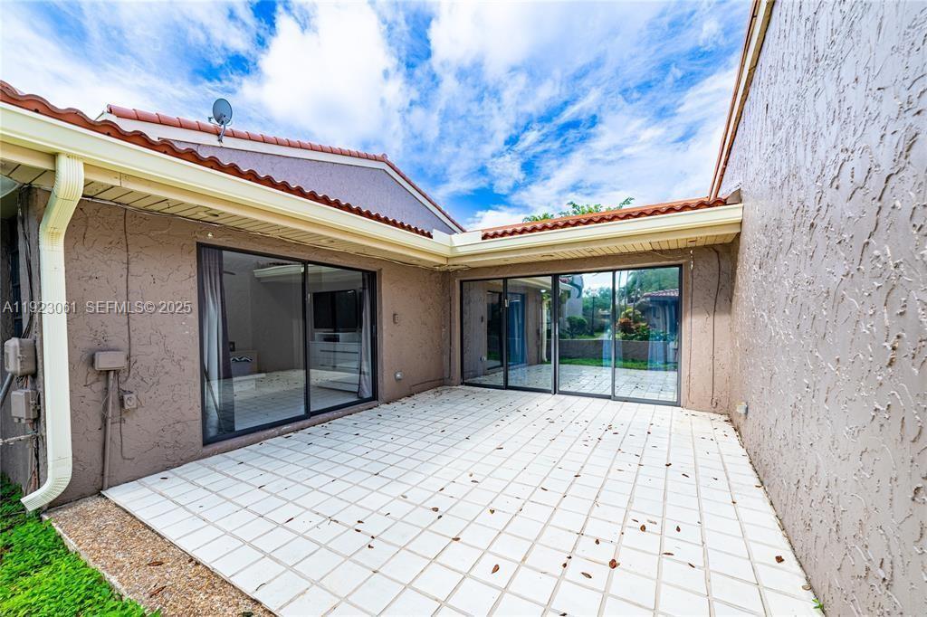 a view of backyard with large window and deck