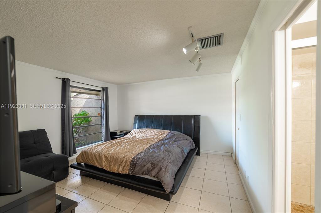 402 St Andrews Road, Unit 55 Hollywood, FL 33021 - Photo 11 of 14 a bedroom with a bed and a window