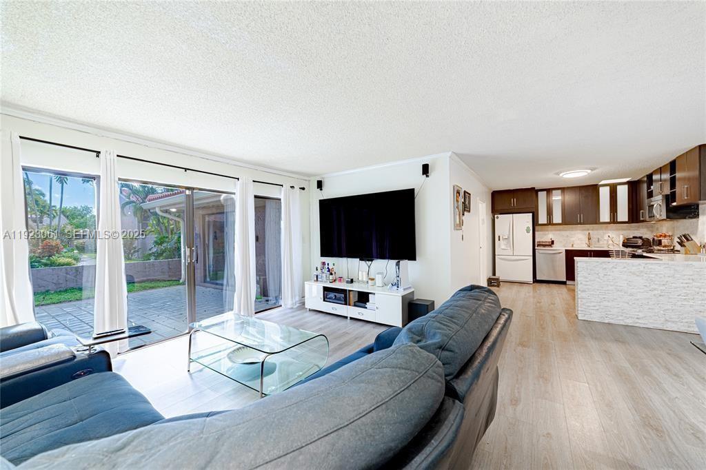 402 St Andrews Road, Unit 55 Hollywood, FL 33021 - Photo 3 of 14 a living room with furniture and a flat screen tv